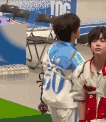 Two Young Boys Are Standing Next To Each Other And One Has The Number 20 On His Back GIF