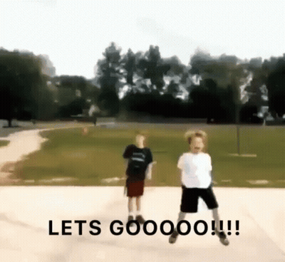 Two Young Boys Jumping In Park Saying Let's Goooo GIF