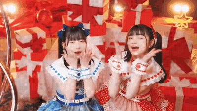 Two Young Girls Sitting By Christmas Tree GIF