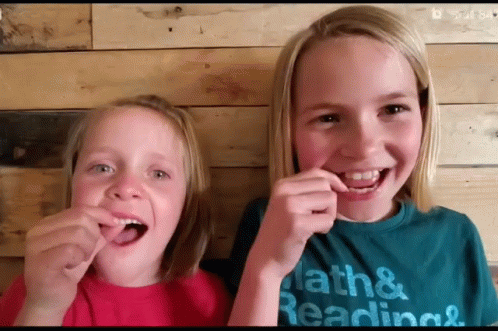 Two Young Girls Wearing Math And Reading T-Shirts GIF