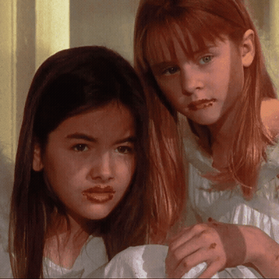 Two Young Girls With Chocolate On Lips GIF