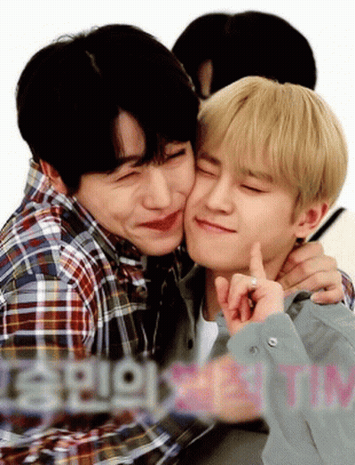 Two Young Men Are Hugging And One Of Them Is Kissing The Other 'S Cheek GIF
