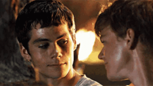 Two Young Men Are Looking At Each Other In A Close Up GIF