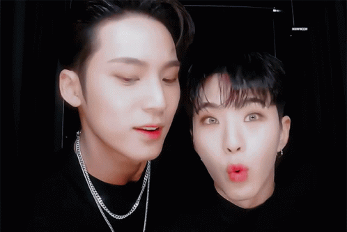 Two Young Men Are Making Funny Faces And One Of Them Is Wearing A Chain Necklace GIF