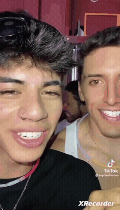 Two Young Men Are Smiling For The Camera And One Has A Nose Ring On His Nose . GIF