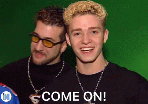 Two Young Men Are Standing Next To Each Other And One Of Them Is Smiling And The Other Is Saying Come On . GIF