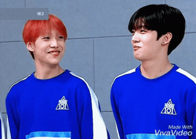 Two Young Men Are Standing Next To Each Other Wearing Blue Shirts That Say 101 On Them . GIF