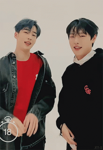 Two Young Men Are Standing Next To Each Other With The Number 18 In The Circle GIF