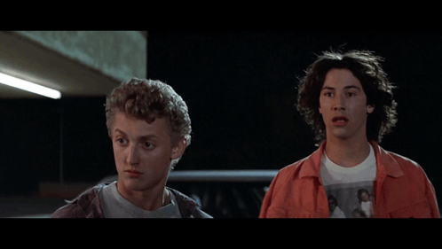 Two Young Men Are Standing Next To Each Other With The Word Bad Behind Them GIF