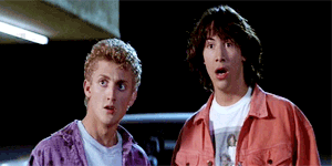 Two Young Men Are Standing Next To Each Other With Their Mouths Open GIF