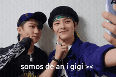 Two Young Men Are Taking A Selfie With A Cell Phone And The Words Somos De An I Gigi GIF