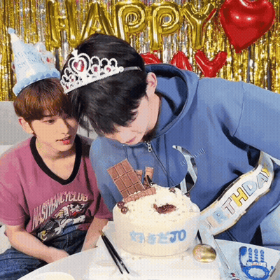 Two Young Men Celebrating Birthday With Cake And Balloons GIF