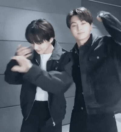 Two Young Men Dancing Next To Each Other GIF