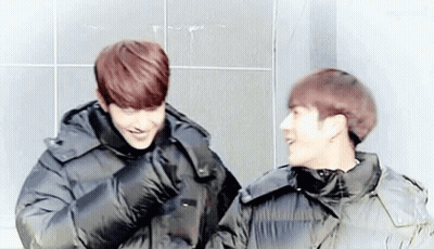 Two Young Men In Black Jackets Laughing GIF