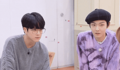 Two Young Men In Glasses And Berets Talking GIF
