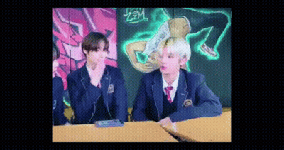 Two Young Men In School Uniforms At Desk GIF