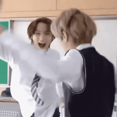 Two Young Men In School Uniforms Standing In Classroom GIF