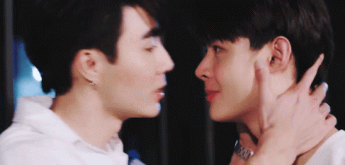 Two Young Men Kissing On Cheek GIF
