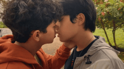 Two Young Men Kissing With Jacket Letter I GIF