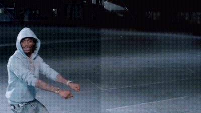 Two Young Men Laughing In Front Of Popsugar Flag At Comic Con GIF
