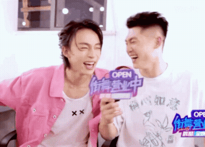 Two Young Men Laughing With Open Sign GIF