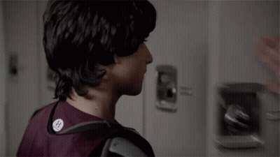 Two Young Men Looking At Each Other In Locker Room GIF