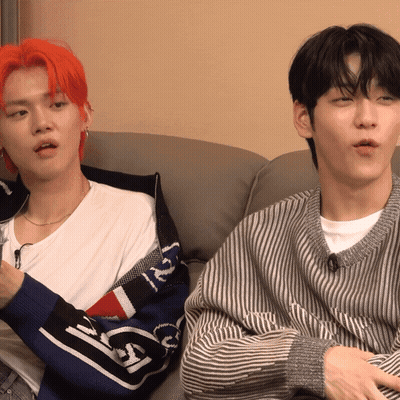 Two Young Men On Couch One Wearing N Sweater GIF