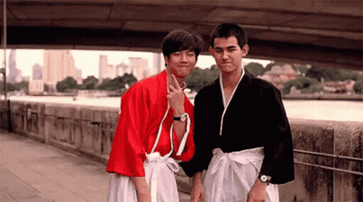 Two Young Men on Sidewalk One in Red Kimono