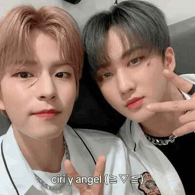 Two Young Men Posing For A Picture With The Words Ciri Y Angel Below Them GIF