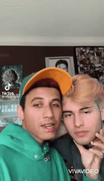 Two Young Men Posing One In Green Hoodie GIF