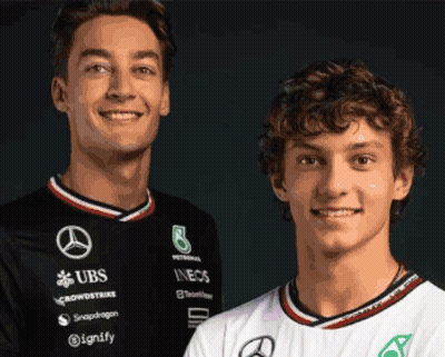 Two Young Men Posing One In UBS Shirt GIF