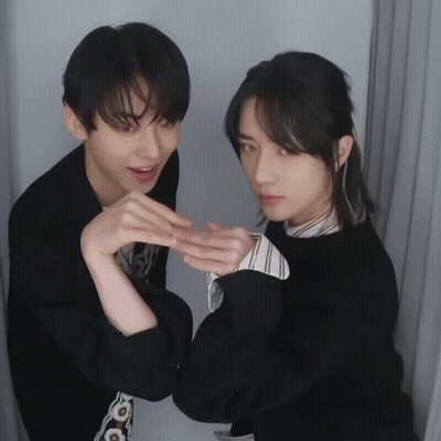 Two Young Men Posing One Making Heart With Hands GIF