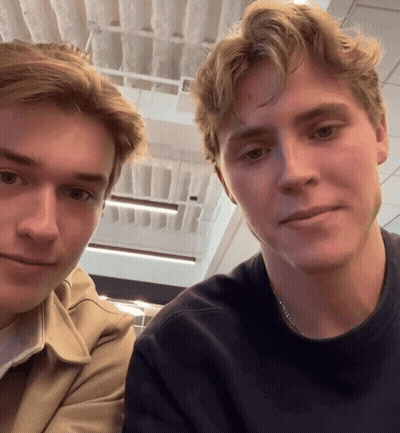 Two Young Men Posing, One Wearing Chain GIF