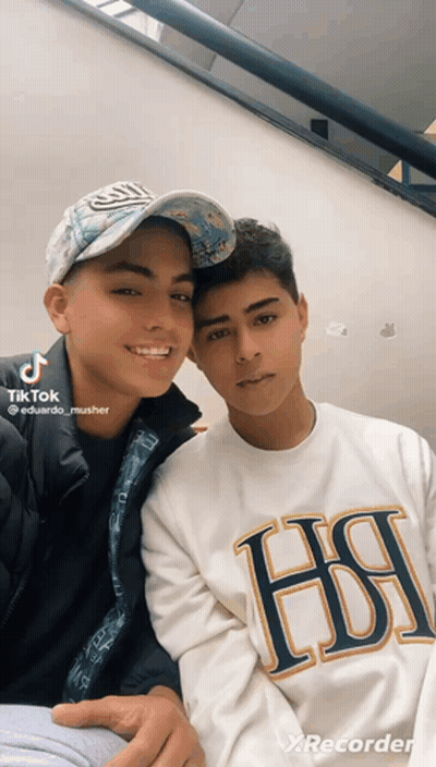Two Young Men Posing One Wearing HSI Shirt GIF