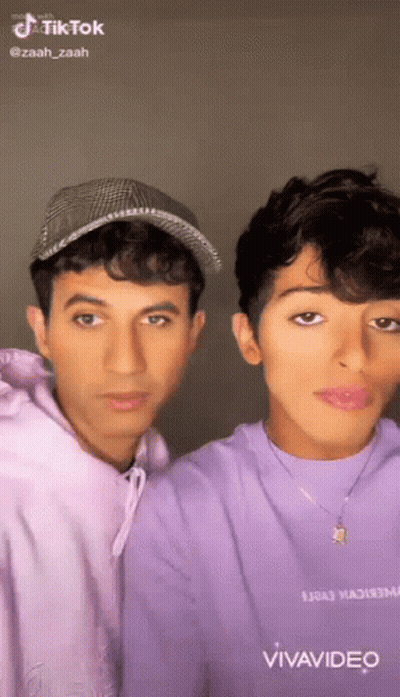 Two Young Men Posing Together GIF