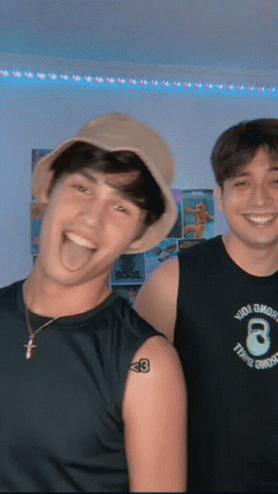 Two Young Men Posing With Tattoo Saying 8 GIF
