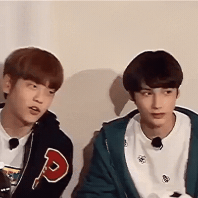 Two Young Men Sitting And Talking GIF