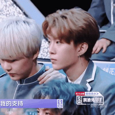 Two Young Men Sitting Next To Each Other GIF