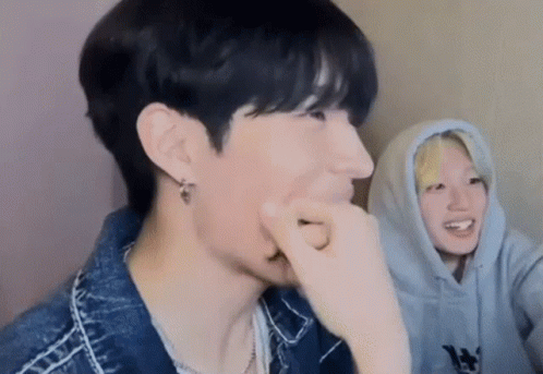 Two Young Men Sitting Together GIF