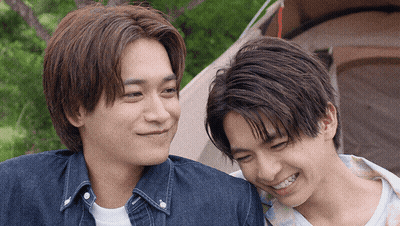 Two Young Men Smiling At Each Other GIF