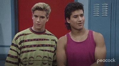 Two Young Men Smiling In Locker Room GIF