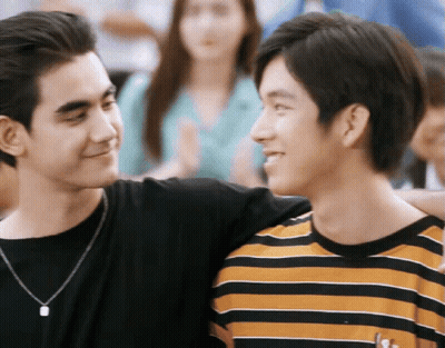 Two Young Men Standing And Smiling GIF