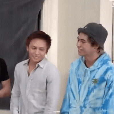 Two Young Men Standing And Smiling GIF
