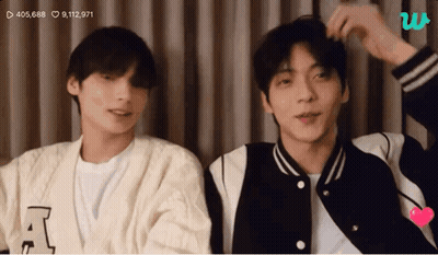 Two Young Men Standing Next To Each Other Looking At Camera GIF