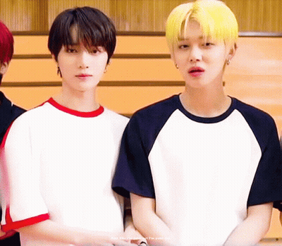 Two Young Men Standing Next To Each Other One With Yellow Hair GIF