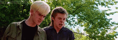 Two Young Men Standing Next To Trees GIF