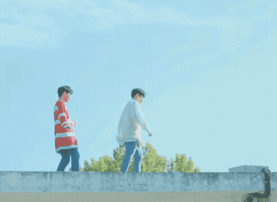 Two Young Men Standing On Ledge GIF