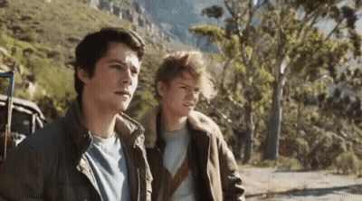 Two Young Men Standing On Mountain Road GIF