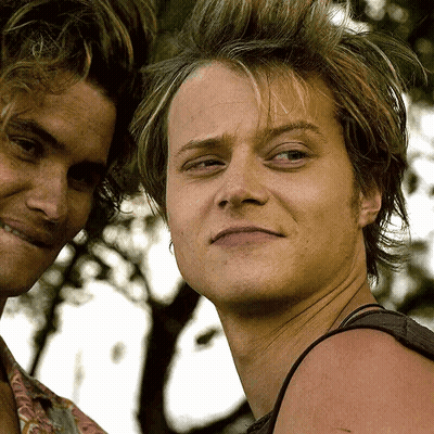 Two Young Men Standing One Smiling GIF