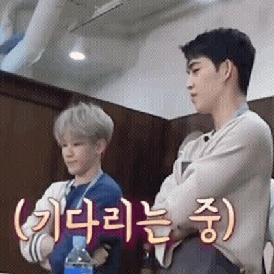 Two Young Men Standing With Water Bottle GIF